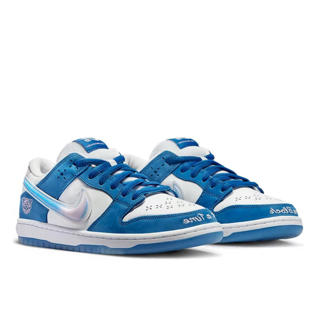 Front view of Nike SB Dunk Low "Born x Raised" in white and blue, highlighting custom cross-hatched toe box perforations and "On The Turf" stitching | Limited edition sneakers
