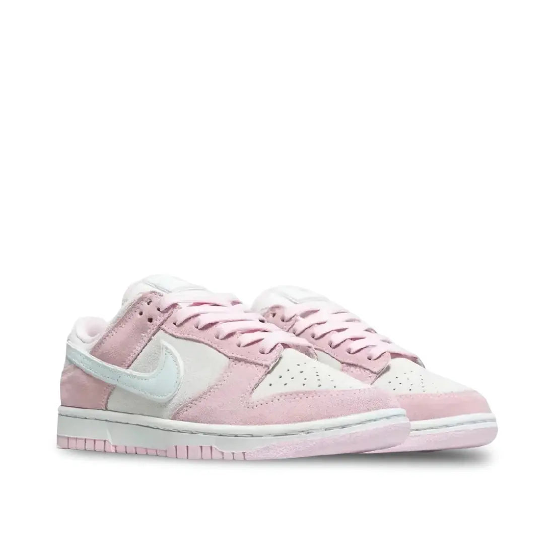 Front view of Nike Women's Dunk Low LX "Pink Foam" in white and light pink, showcasing perforated toe box and pink laces