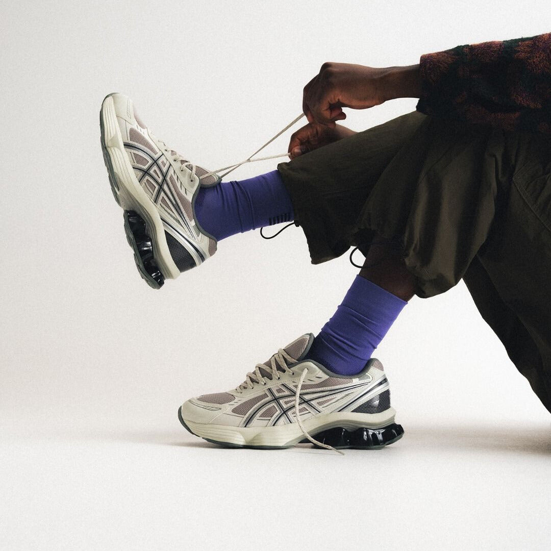 Man’s feet wearing sporty sneakers, standing on a street, showcasing style and comfort for everyday wear