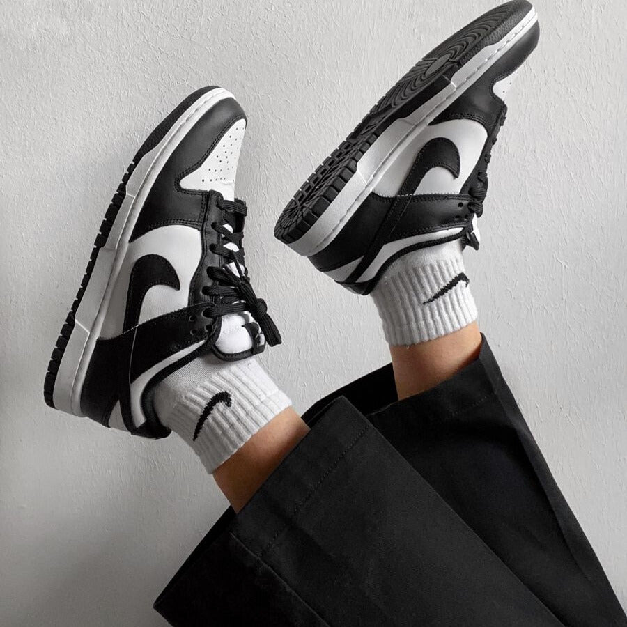 Woman’s feet wearing stylish sneakers, designed for comfort and everyday wear.