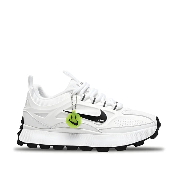 Side view of Nike Bailleli in white/black, showing layered upper, chunky midsole, and smiley charm on laces.