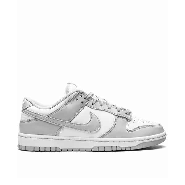 Nike Dunk Low 'Grey Fog' sneaker side view showing crisp white leather base, light grey fog overlays, and white midsole