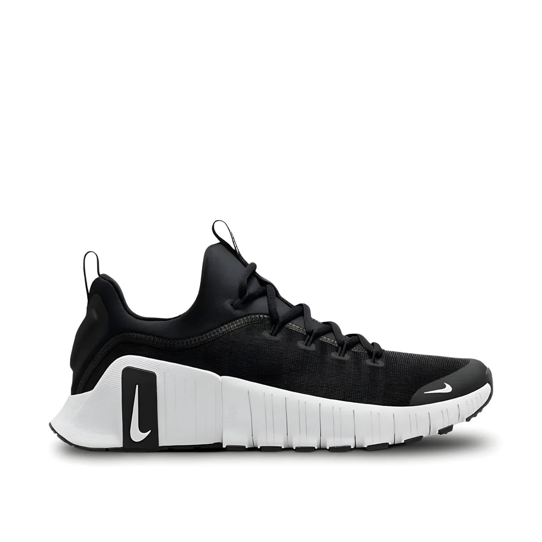 Nike Free Metcon 6 "Black and White" training shoe side view showing black upper, white accents, flexible sole, and durable rubber outsole.