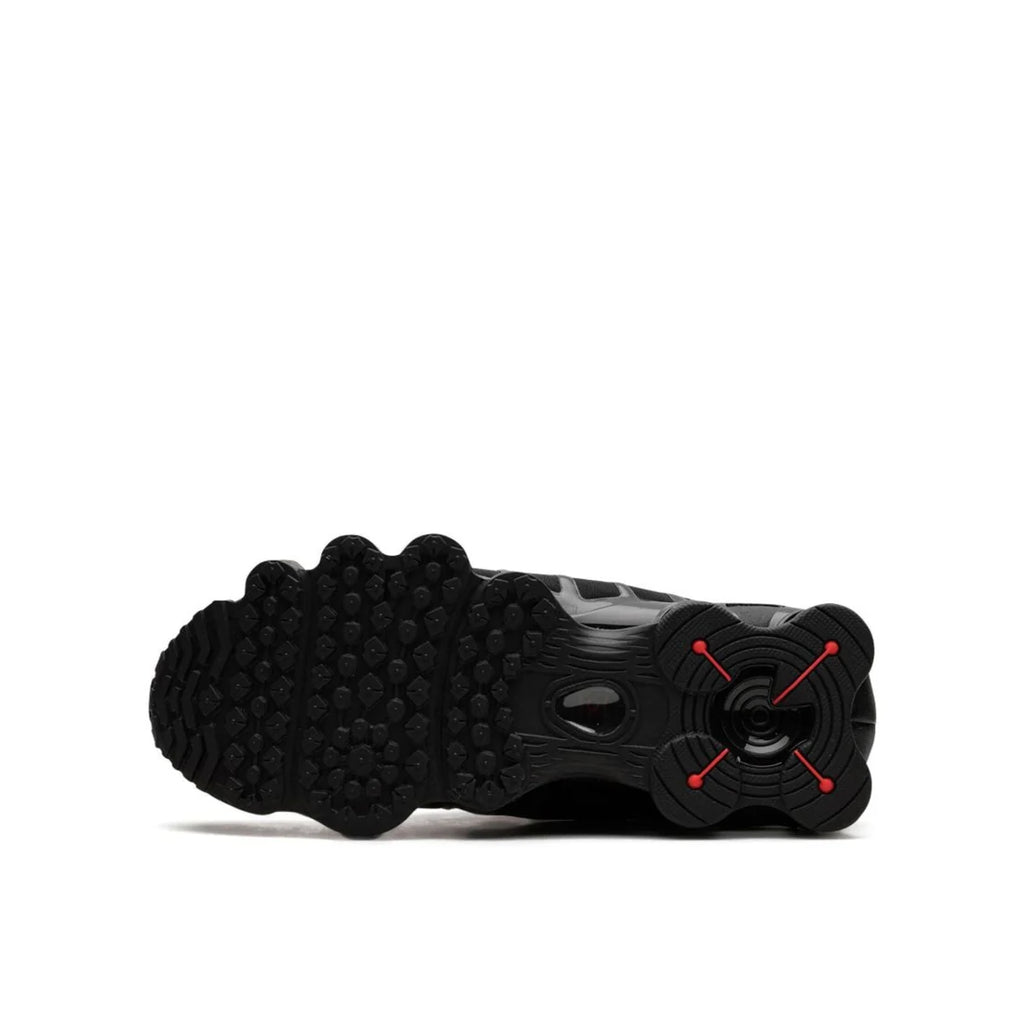 Nike Shox "Black Max Orange" sole view displaying durable black rubber outsole with orange accents and visible Shox column cushioning system