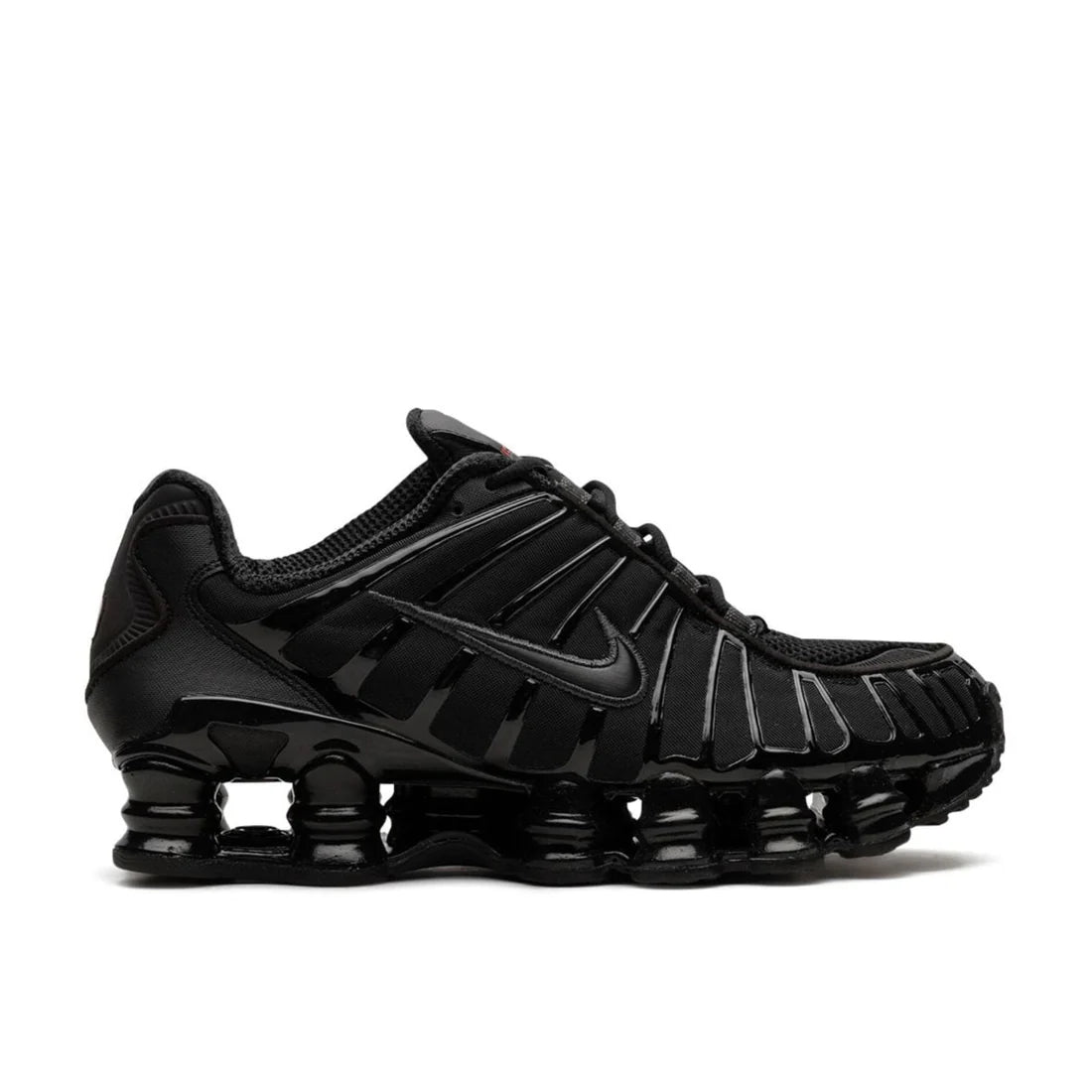 Nike Shox "Black Max Orange" sneaker side profile showing black upper, vibrant orange Shox columns in heel, and classic Swoosh logo
