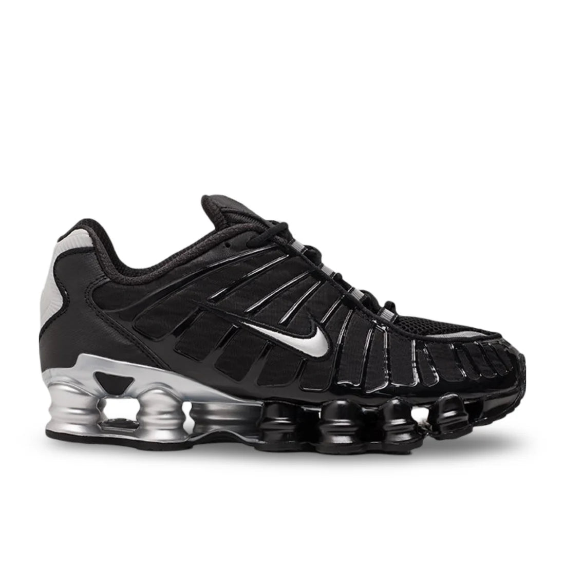 Nike Shox TL "Black/Metallic Silver" sneaker side profile showing black mesh upper, metallic silver details, and a striking silver sole with full-length Shox columns