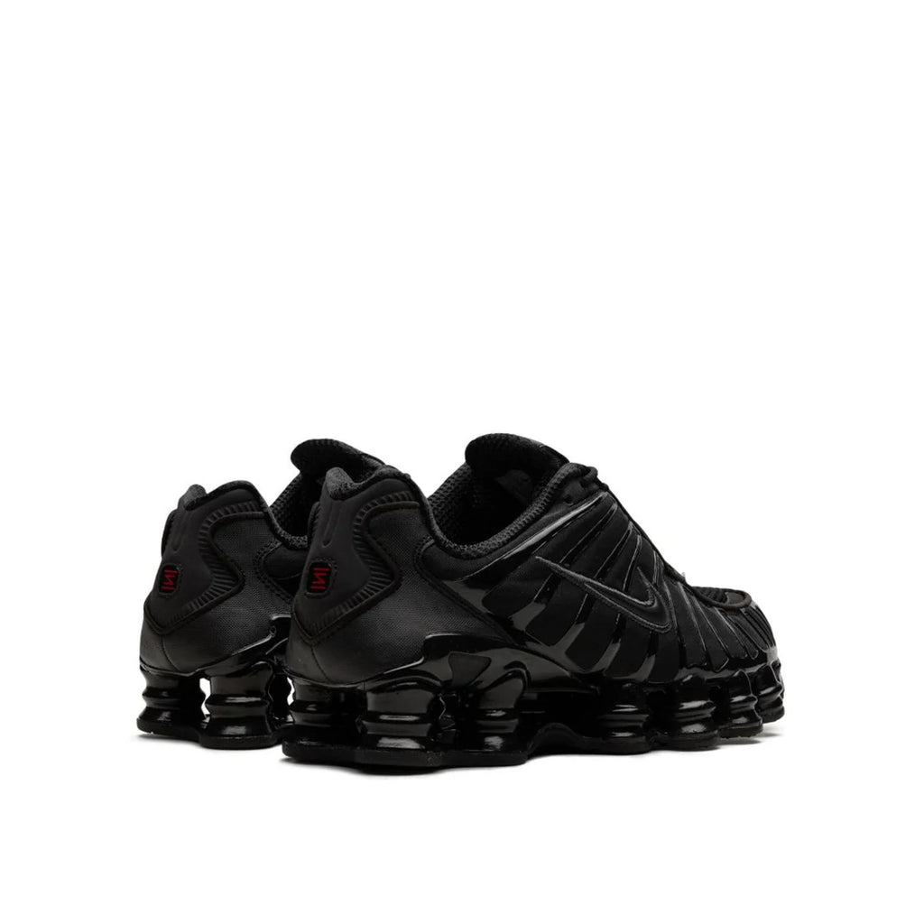 Back view of Nike Shox "Black Max Orange" sneaker, showing black and orange upper materials