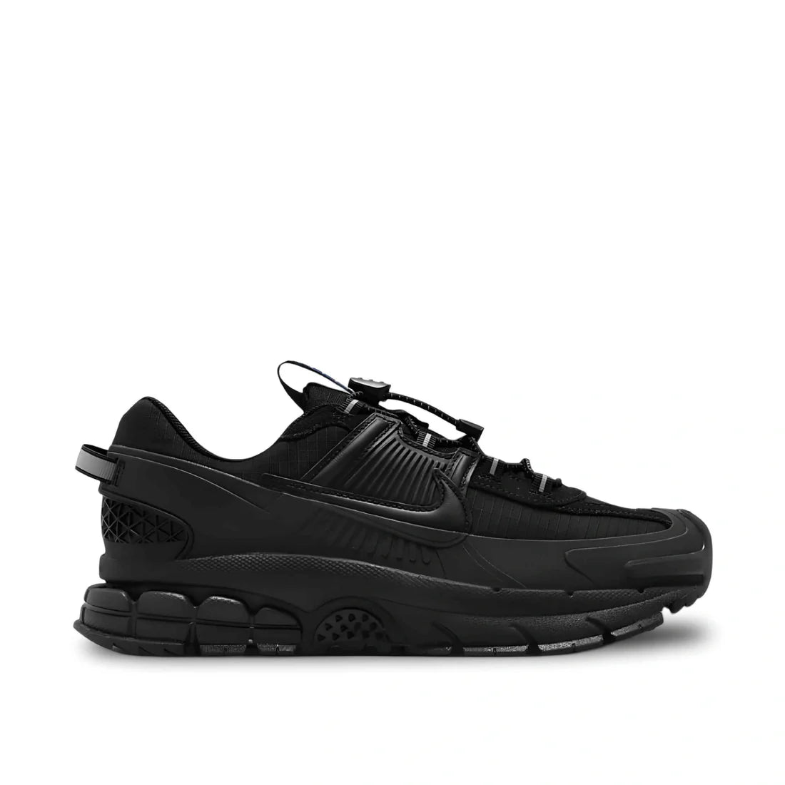 Side view of Nike Vomero Roam Winterized in all-black, showing toggle lacing, ripstop upper, and rugged outsole grip.