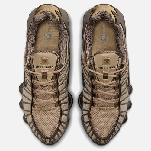 Pair of beige sneakers with a textured design on a white background