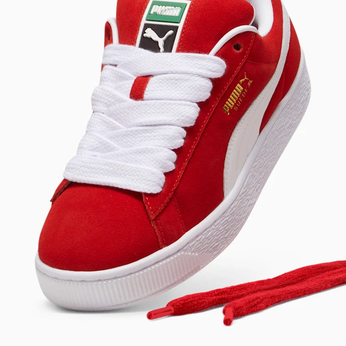 Red and white Puma sneaker with visible brand logo on a white background